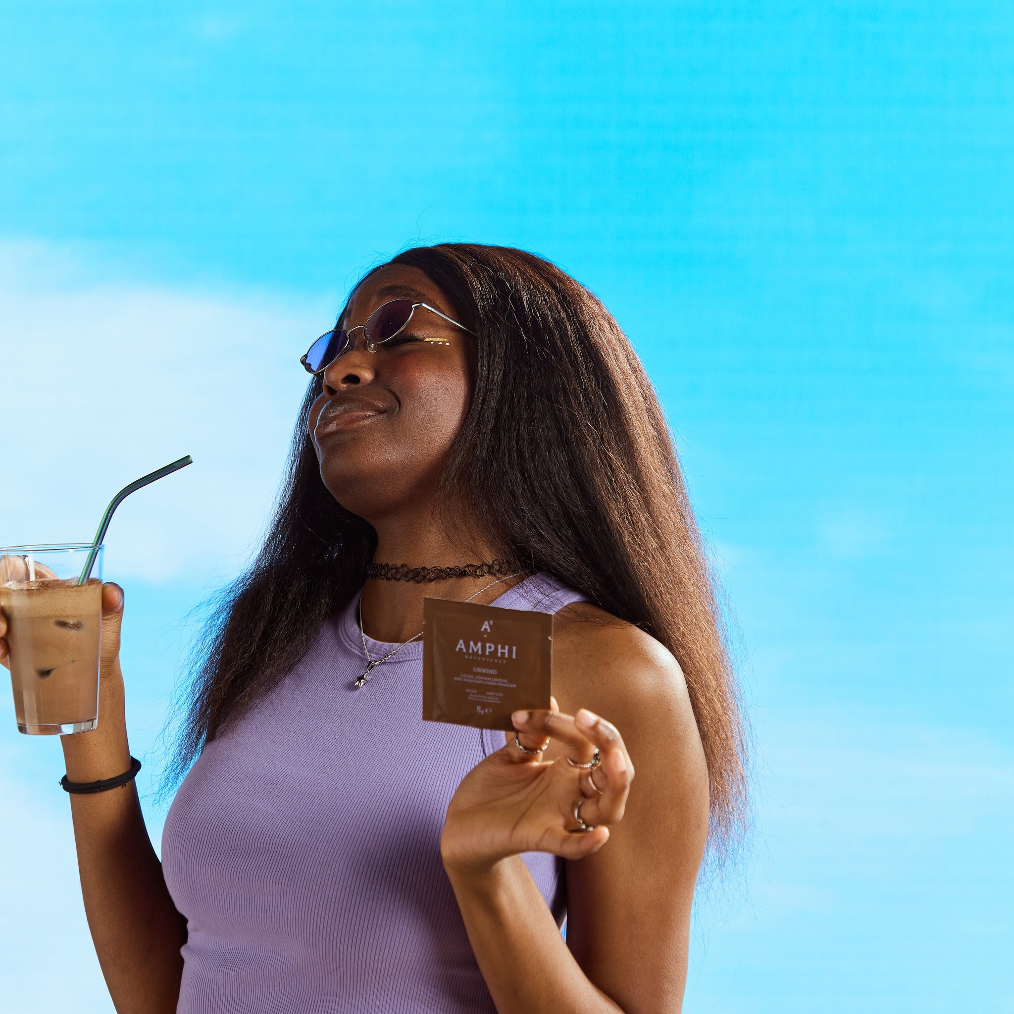 A girl holding a healthy cacao drink by Amphi Botanicals